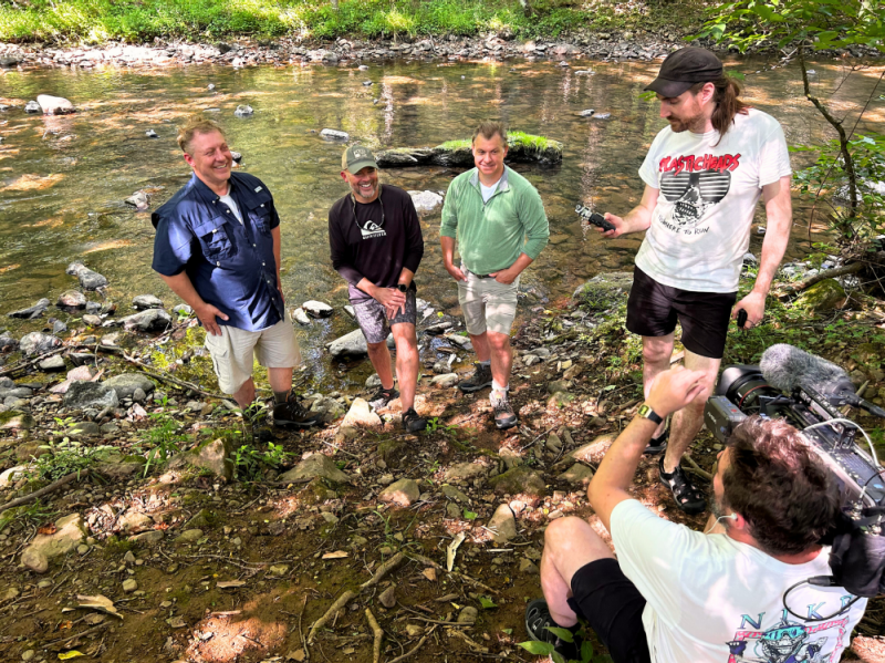 (From left to right) Martin Kratt, Bill Hopkins, and Chris Kratt wait as the crew sets up a shot
