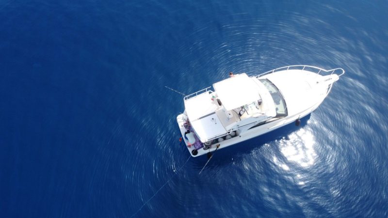 An aerial view of a boat on the open sea.