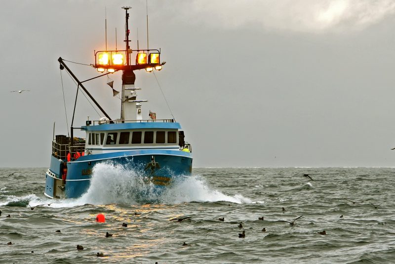A commercial fishing vessel on the open sea.