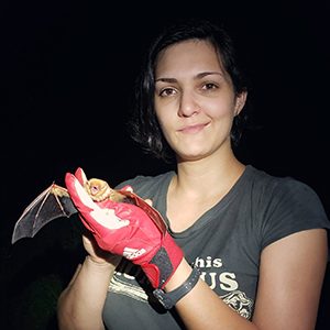 picture of graduate student, Hila Taylor holding a bat