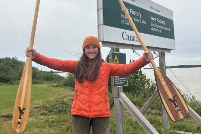 Olivia Bledsoe celebrating at York Factory after finishing a 1,300-mile canoe trip
